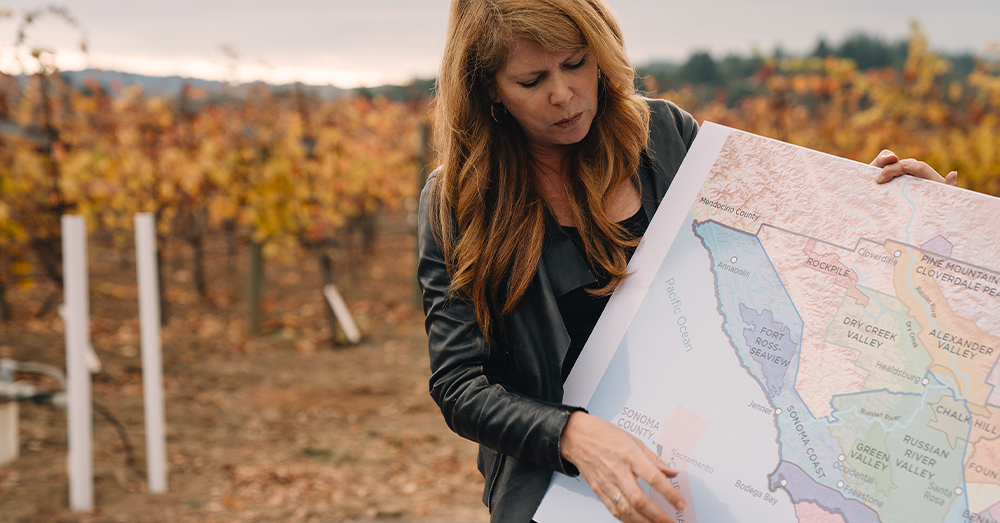 Ondine Chattan, winemaker looking at map.